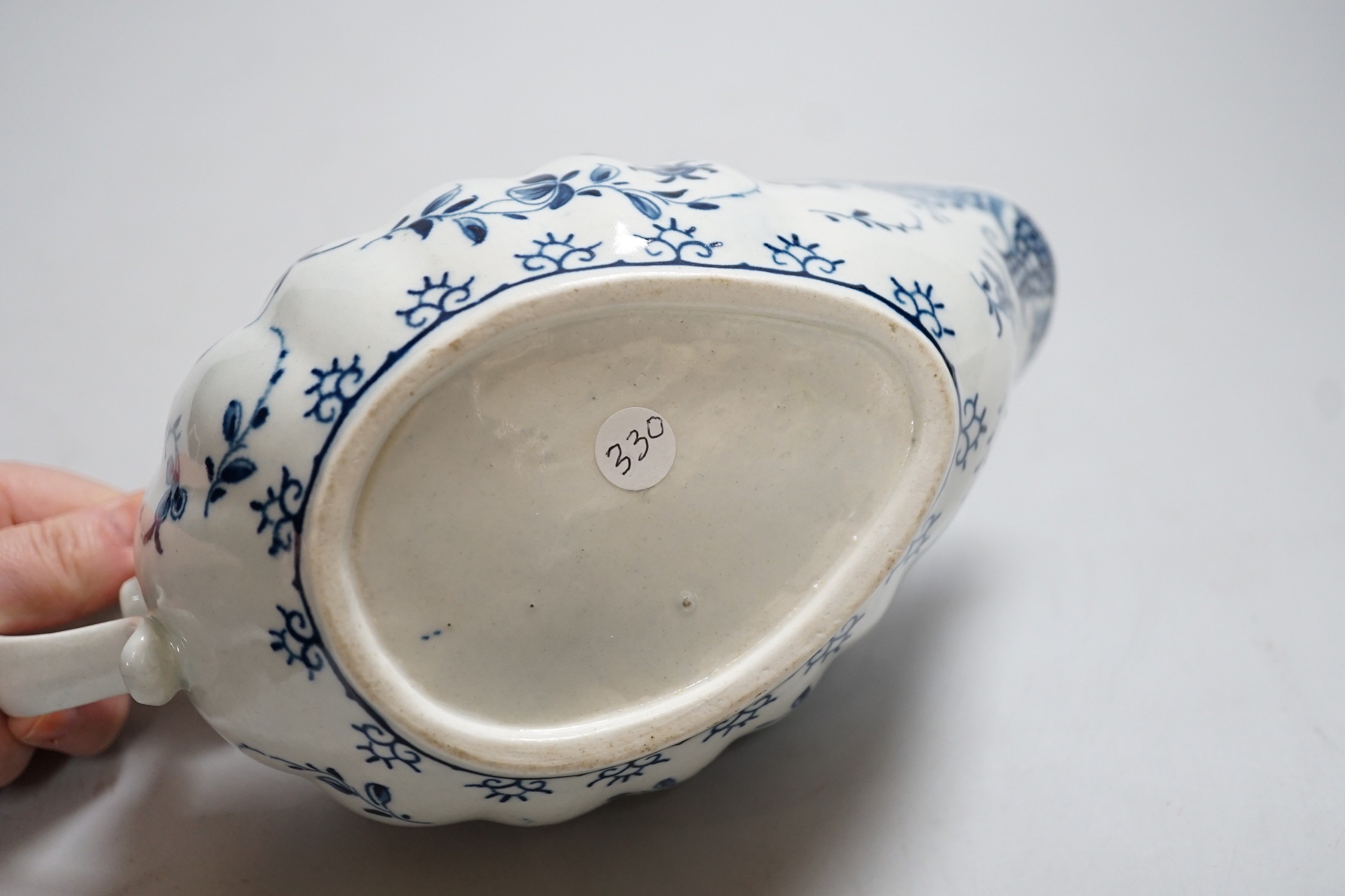 An 18th century Worcester sauceboat painted in underglaze blue in the full moon pattern. 23cm wide